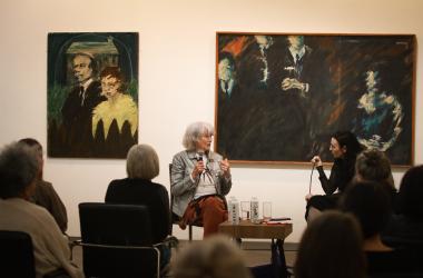 Event in gallery with two women speaking 